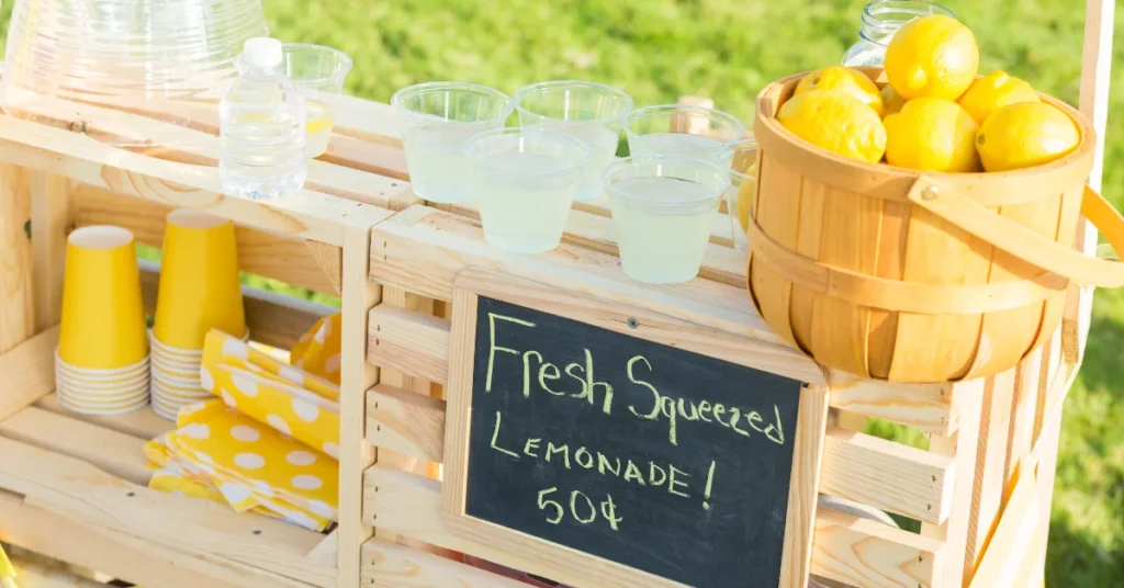 Lemonade stand showing fresh drinks and pricing — a fun way for teens in New Zealand to make money